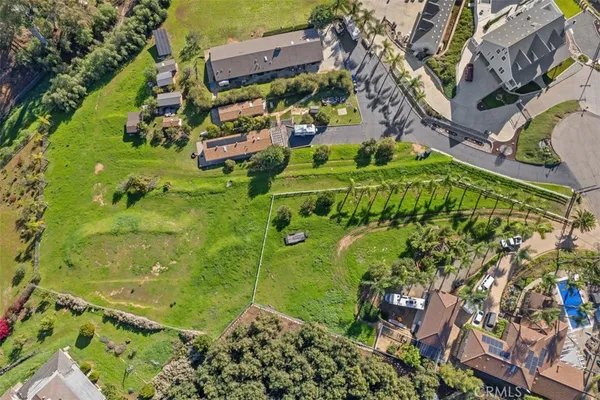 an aerial view of a residential houses with outdoor space
