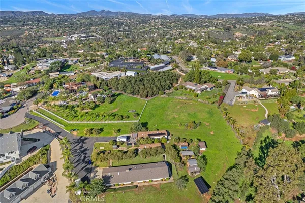 an aerial view of a residential houses with outdoor space