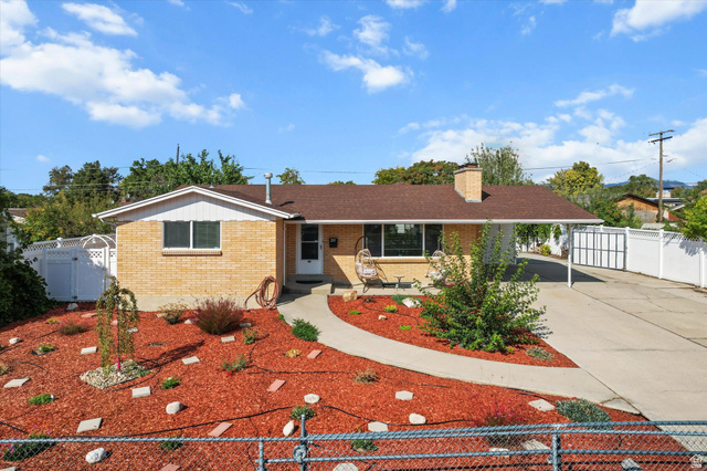 215 Carol Way Midvale, UT 84047 - Photo 23 of 30 Single story home featuring driveway, brick siding, a gate, and an attached carport