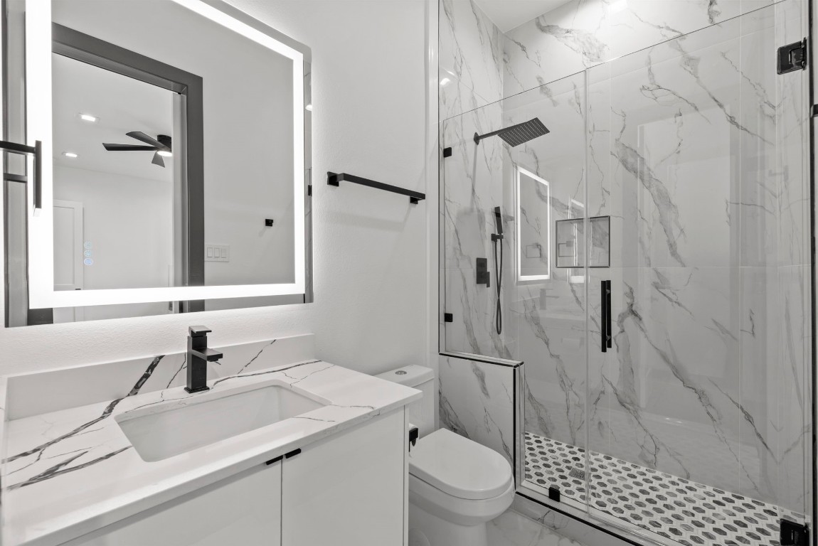 3114 Clay Street Houston, TX 77003 - Photo 9 of 28 a bathroom with a sink toilet a mirror and shower