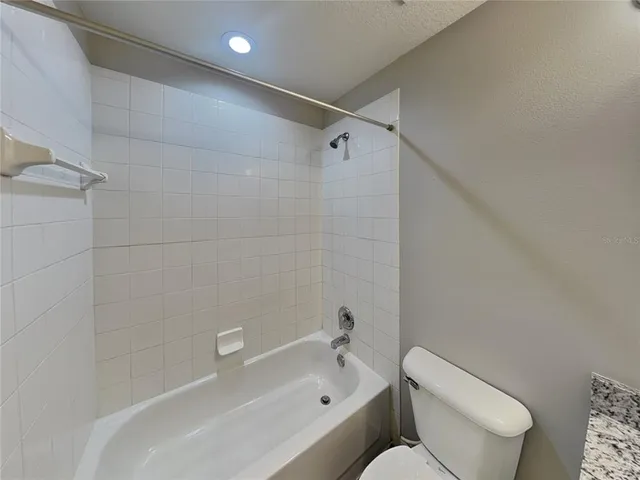 a bathroom with a toilet and a bathtub