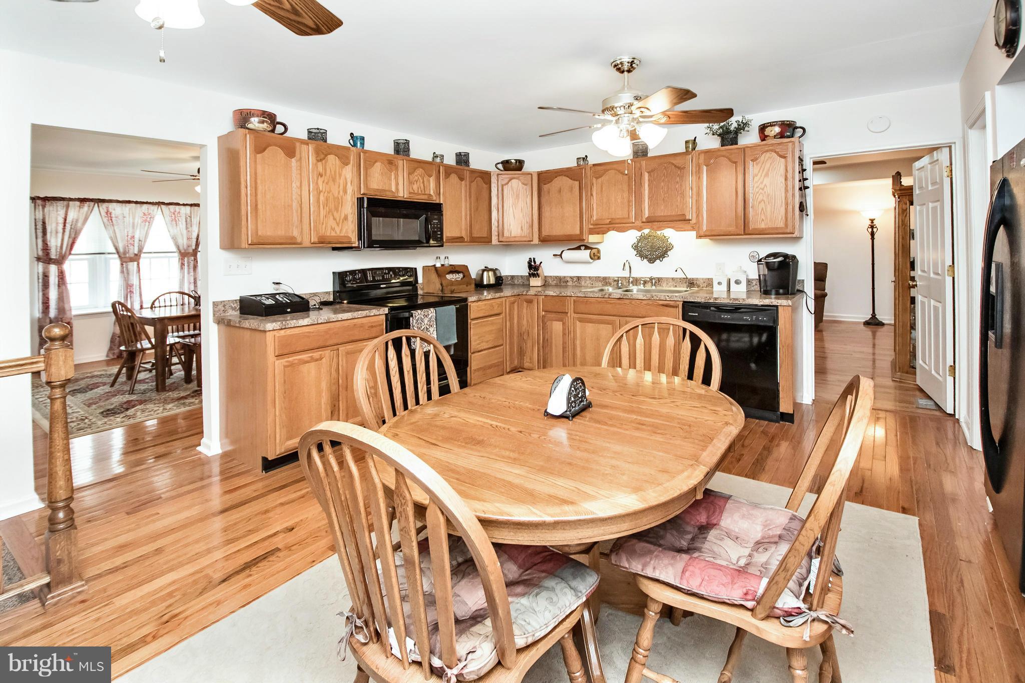 6101 Ridge Tree Road Fredericksburg, VA 22407 - Photo 16 of 30 a dining table with chairs and kitchen view