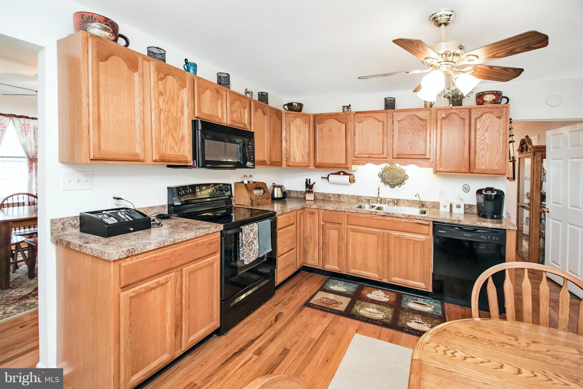6101 Ridge Tree Road Fredericksburg, VA 22407 - Photo 17 of 30 a kitchen with a stove a sink dishwasher and a microwave oven with cabinets