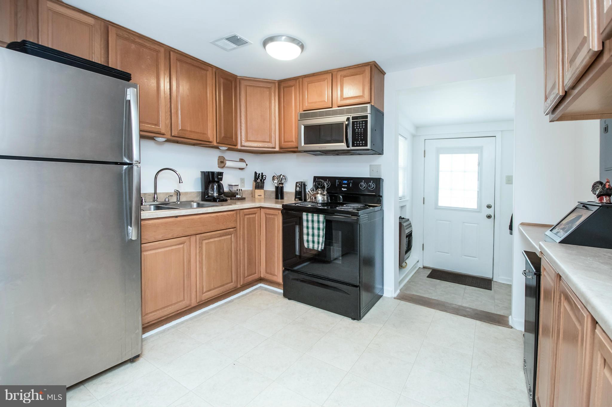 6101 Ridge Tree Road Fredericksburg, VA 22407 - Photo 26 of 30 a kitchen with stainless steel appliances granite countertop a refrigerator stove a sink and dishwasher