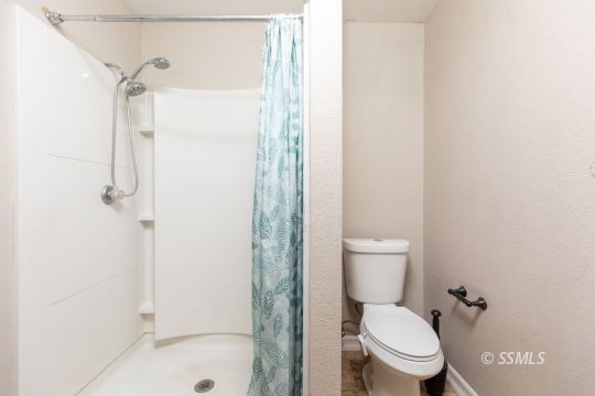 613 South Silver Ridge Street Ridgecrest, CA 93555 - Photo 24 of 26 a white toilet sitting next to a shower