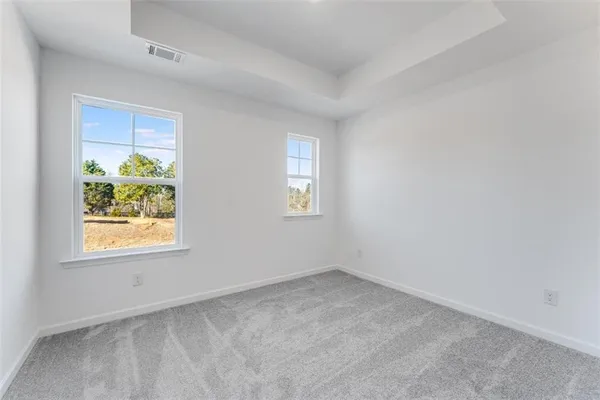 an empty room with windows and entrance