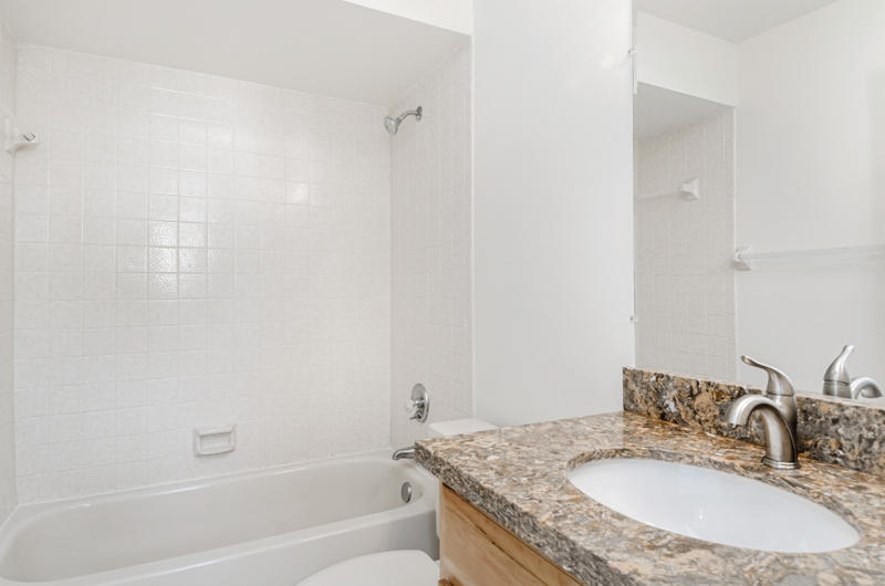 363 West Camino Real, Unit 4 Boca Raton, FL 33432 - Photo 35 of 37 a bathroom with a granite countertop sink a mirror and a bathtub