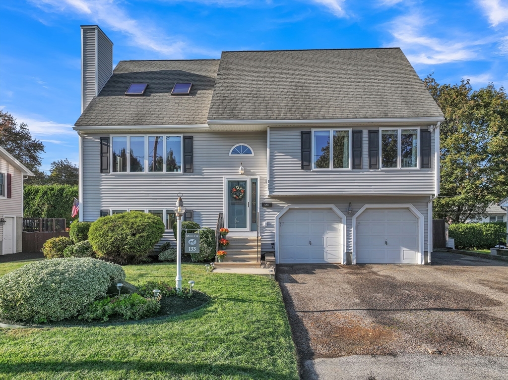 133 Derby Street Worcester, MA 01604 - Photo 1 of 42 a front view of a house with a garden and plants