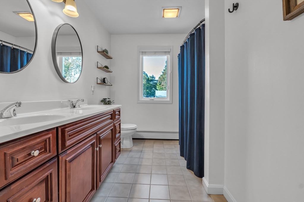 133 Derby Street Worcester, MA 01604 - Photo 19 of 42 a spacious bathroom with a double vanity sink and a mirror