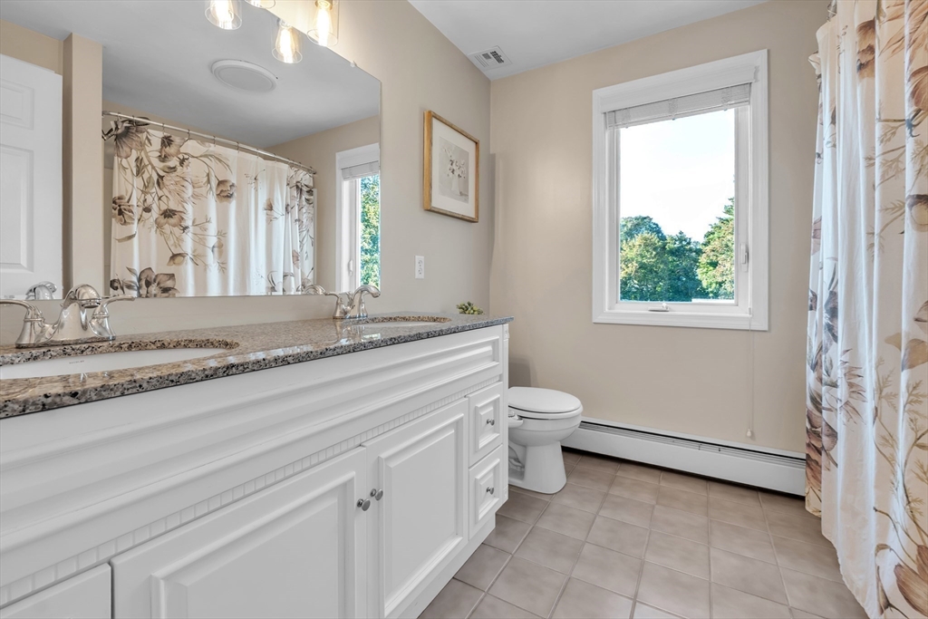 133 Derby Street Worcester, MA 01604 - Photo 26 of 42 a bathroom with a granite countertop sink a mirror and a toilet