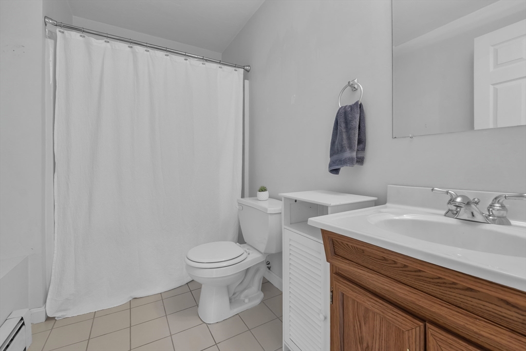133 Derby Street Worcester, MA 01604 - Photo 34 of 42 a bathroom with a sink a toilet and a mirror