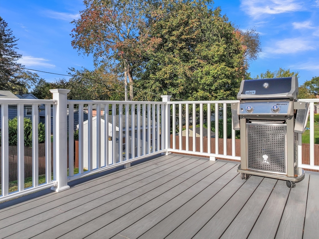 133 Derby Street Worcester, MA 01604 - Photo 35 of 42 a balcony with wooden floor and fence