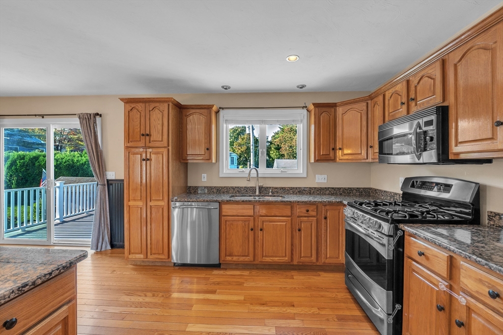 133 Derby Street Worcester, MA 01604 - Photo 6 of 42 a kitchen with stainless steel appliances granite countertop a stove a sink dishwasher a refrigerator and a microwave