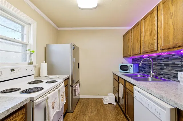 a kitchen with stainless steel appliances granite countertop a stove a refrigerator and a refrigerator