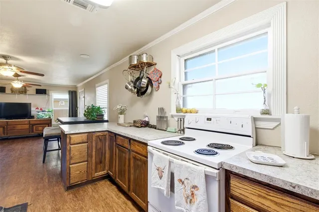 a kitchen with a sink a stove and cabinets