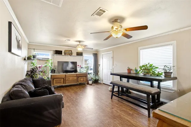 a living room with furniture ceiling fan and a window