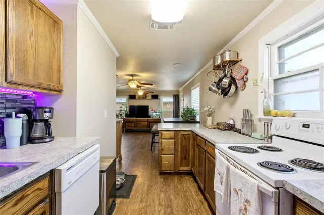 a kitchen with a sink a stove and cabinets