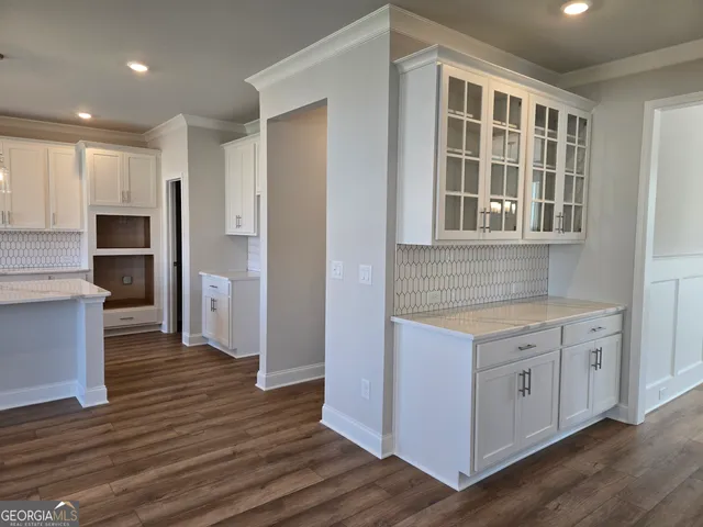 a bathroom with a granite countertop toilet sink and mirror