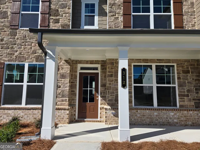 a view of a hallway view with wooden floor and staircase