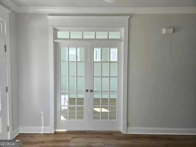 a view of front door and livingroom with wooden floor
