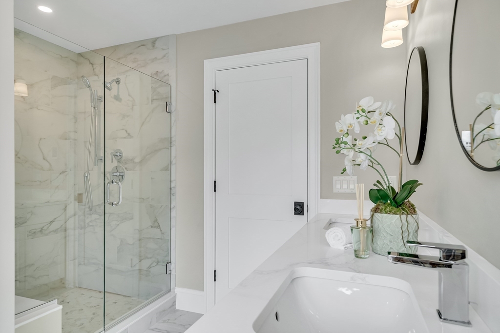 17 Hamilton Road Lexington, MA 02420 - Photo 25 of 42 a bathroom with a sink a mirror and a shower