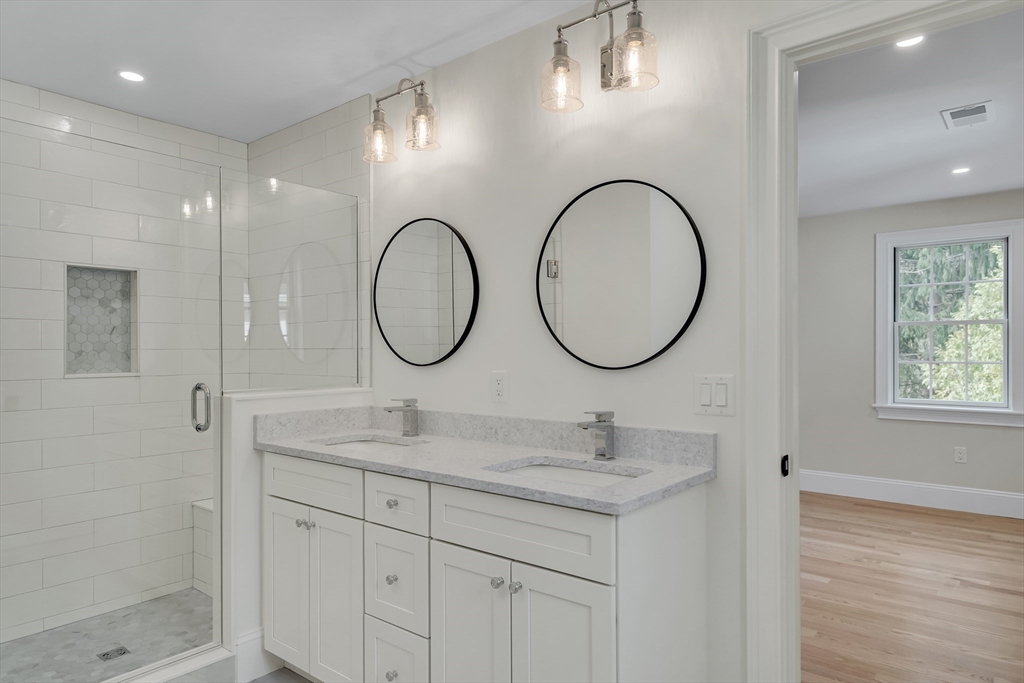 17 Hamilton Road Lexington, MA 02420 - Photo 30 of 42 a bathroom with a double vanity sink and a mirror