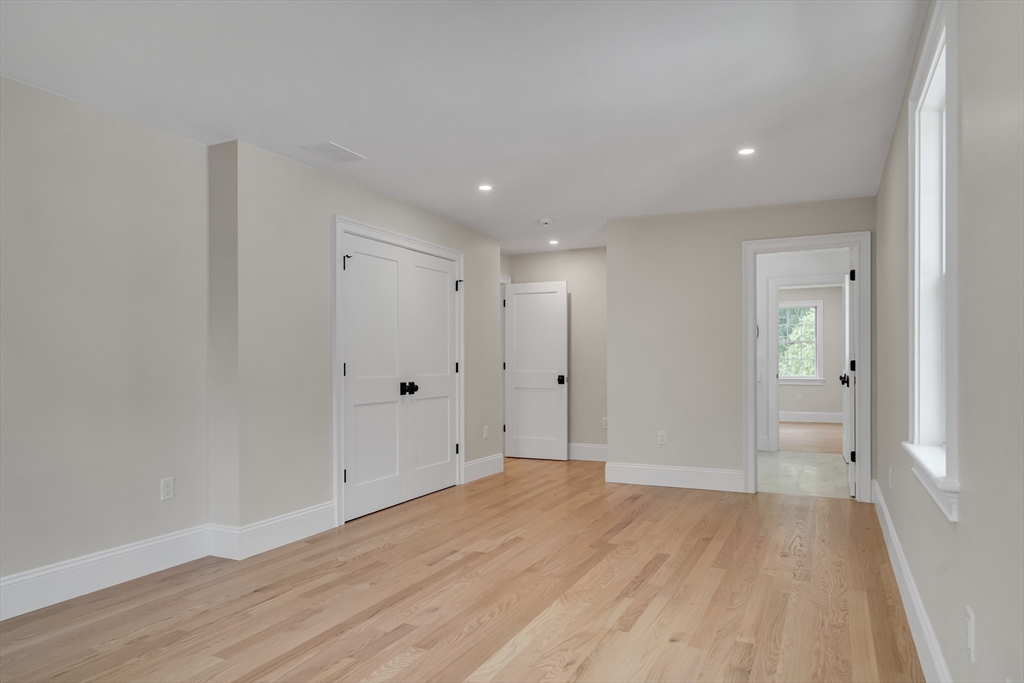 17 Hamilton Road Lexington, MA 02420 - Photo 32 of 42 a view of a big room with wooden floor and windows
