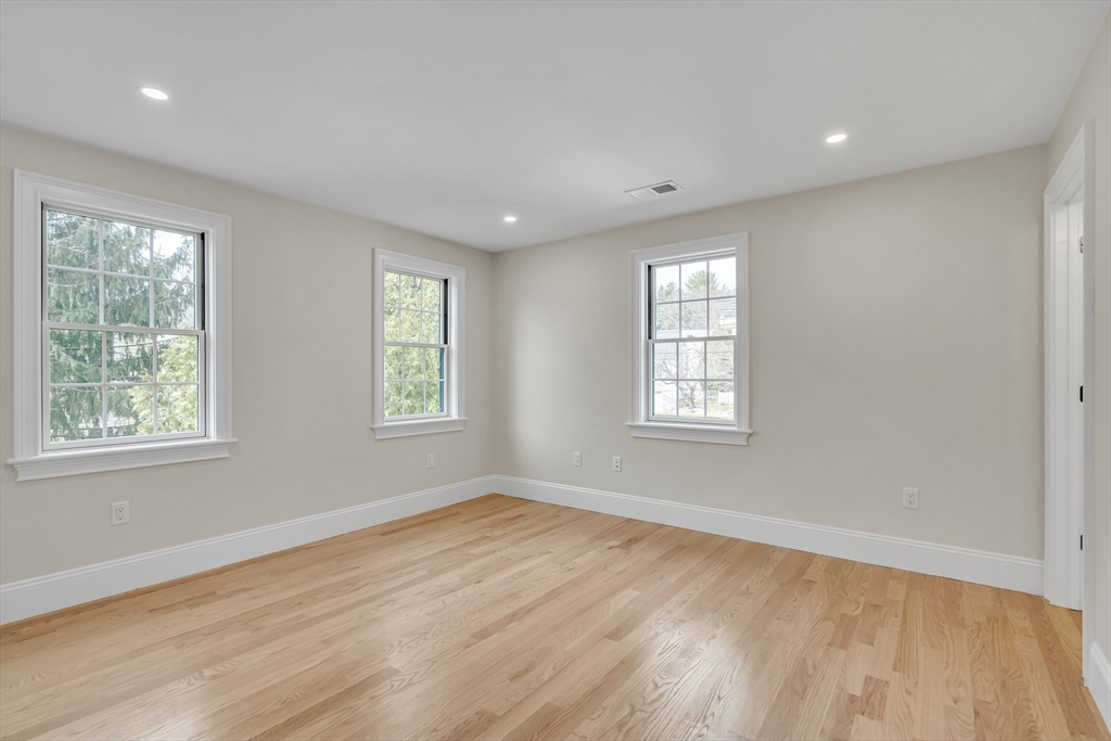17 Hamilton Road Lexington, MA 02420 - Photo 33 of 42 a view of an empty room with wooden floor and a window
