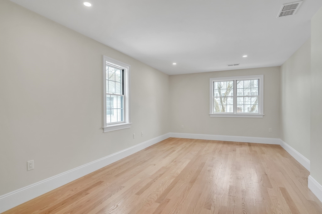 17 Hamilton Road Lexington, MA 02420 - Photo 35 of 42 an empty room with wooden floor and windows