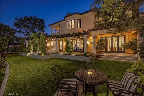 a front view of a house with garden and sitting area