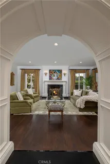 a living room with furniture large window and a fireplace