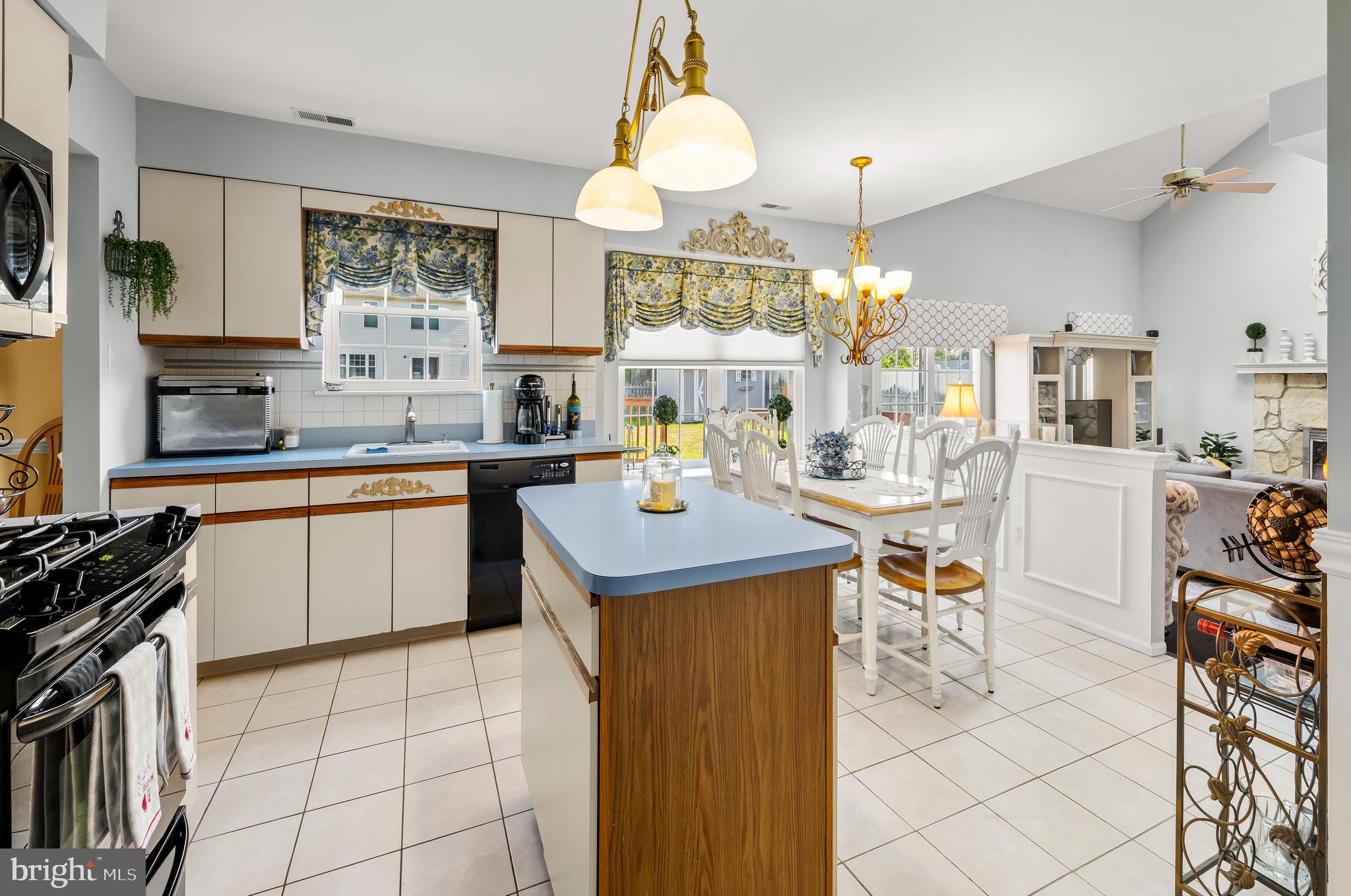 22 Trapper Road Sewell, NJ 08080 - Photo 5 of 20 a kitchen with a sink a stove cabinets dining table and chairs