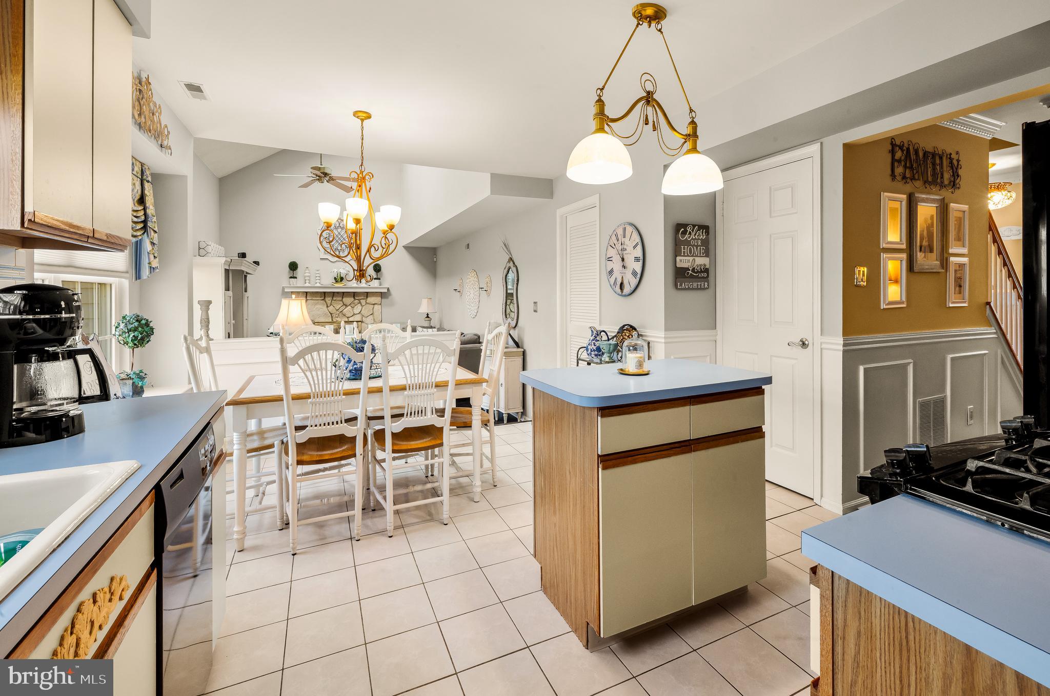 22 Trapper Road Sewell, NJ 08080 - Photo 7 of 20 a dining hall with granite countertop a stove a sink a dining table and chairs with wooden floor