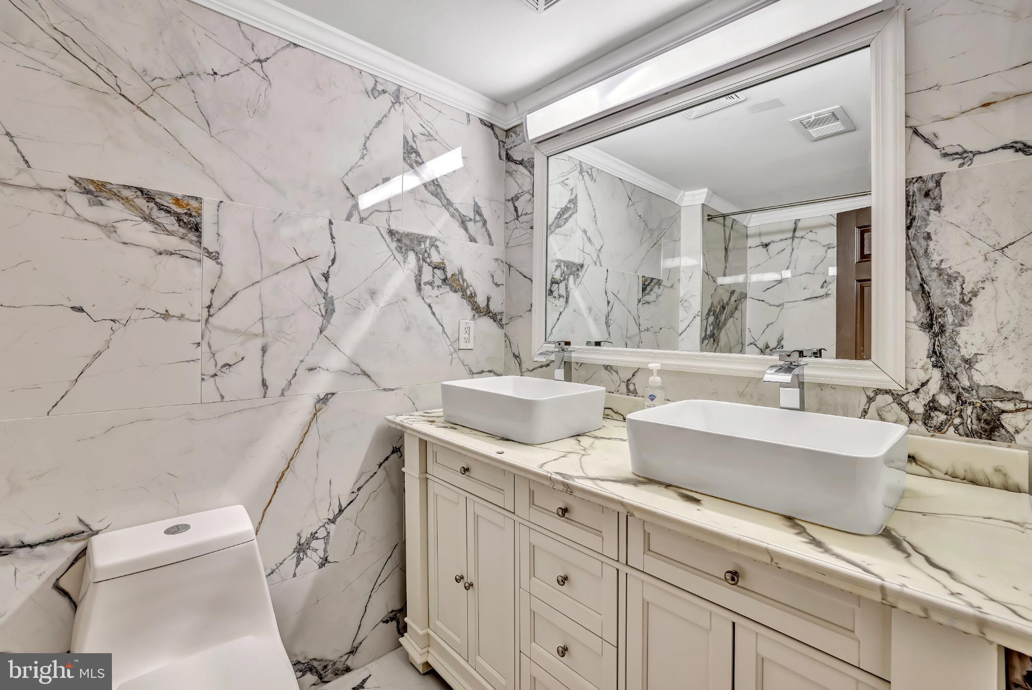 1475 Mt Holly Road, Unit O4 Beverly, NJ 08010 - Photo 12 of 18 a spacious bathroom with double vanity sink a mirror and a toilet