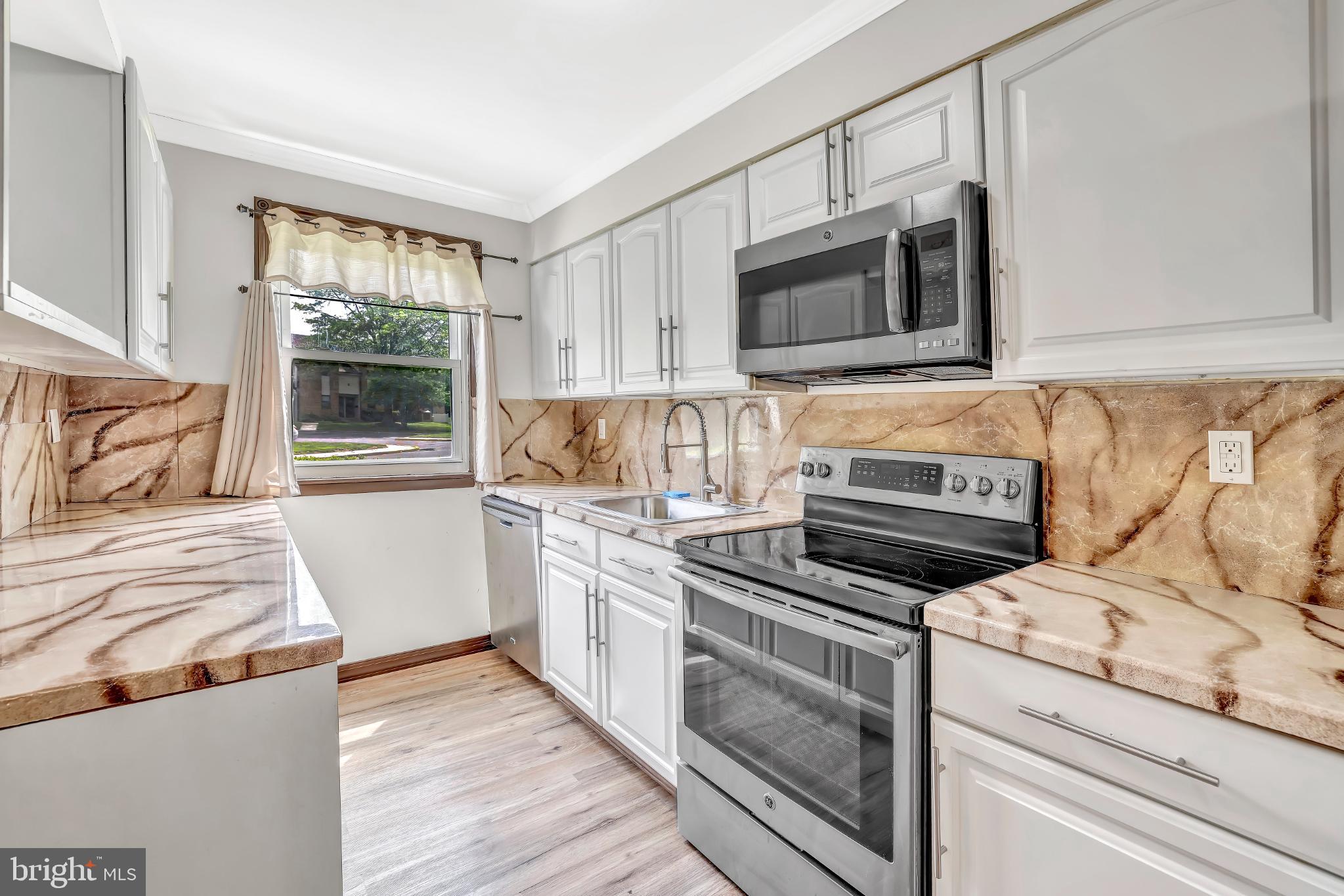 1475 Mt Holly Road, Unit O4 Beverly, NJ 08010 - Photo 4 of 18 a kitchen with a stove and a microwave