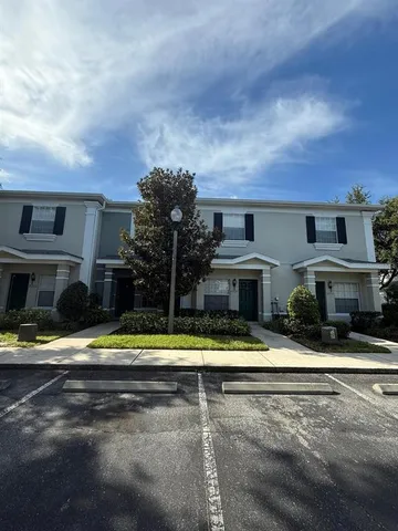 a view of house with yard and large trees