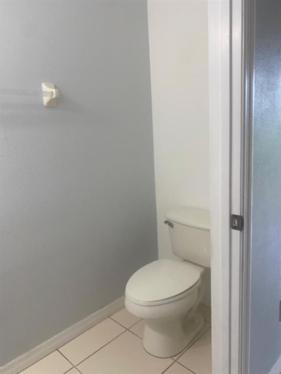 9323 Flowering Cottonwood Road Orlando, FL 32832 - Photo 11 of 23 a white toilet sitting next to a white cabinet