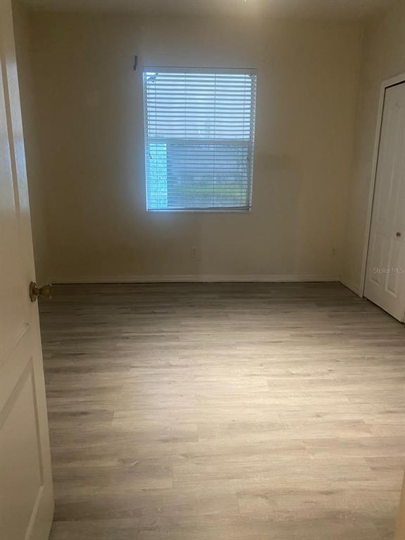 9323 Flowering Cottonwood Road Orlando, FL 32832 - Photo 18 of 23 a view of an empty room with a window