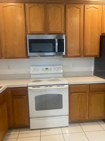 a stove top oven sitting inside of a kitchen
