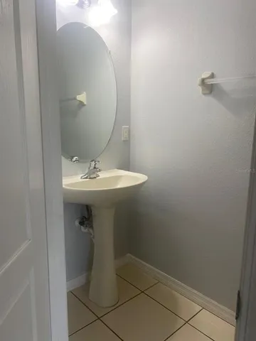 a bathroom with a sink toilet and mirror