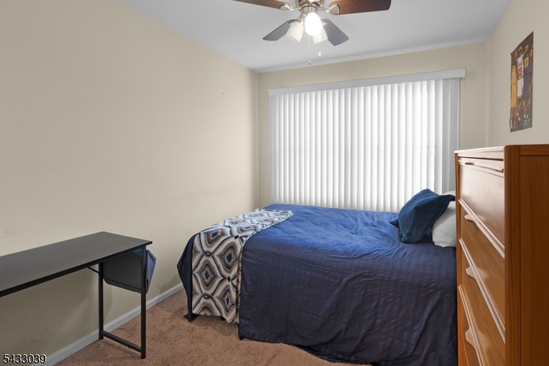 158 Autumn Ridge Road Morris Plains, NJ 07950 - Photo 19 of 26 a bedroom with a bed and a chandelier