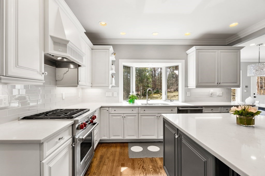 12 Glen Brook Road Wellesley, MA 02481 - Photo 10 of 35 a kitchen with a sink a stove cabinets and a window