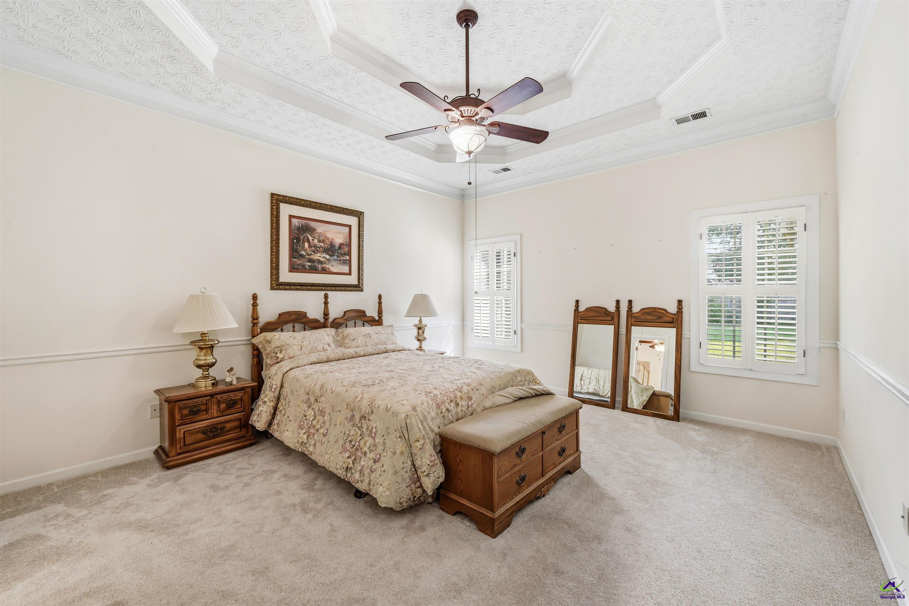 206 North Hampton Place Perry, GA 31069 - Photo 13 of 20 a spacious bedroom with a bed and a table