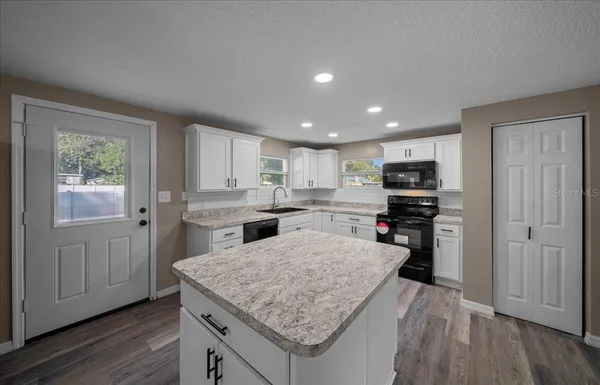 a kitchen with a stove a refrigerator and a sink