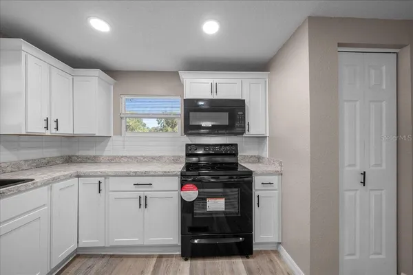 a kitchen with stainless steel appliances granite countertop a stove and a refrigerator
