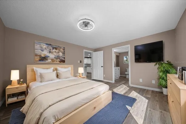 a bedroom with a bed and a flat screen tv