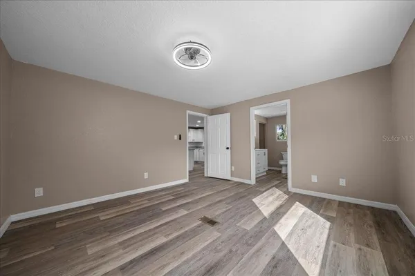 a view of a room with wooden floor and closet