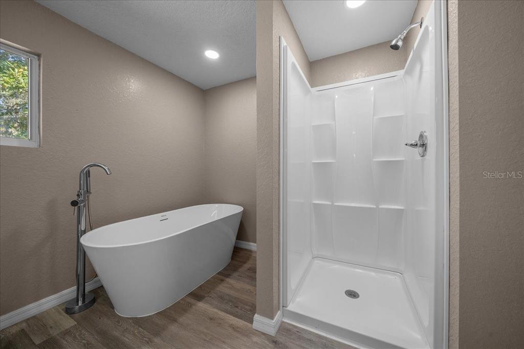 339 Southwest 83rd Street Ocala, FL 34476 - Photo 19 of 34 a bathroom with a bathtub and shower