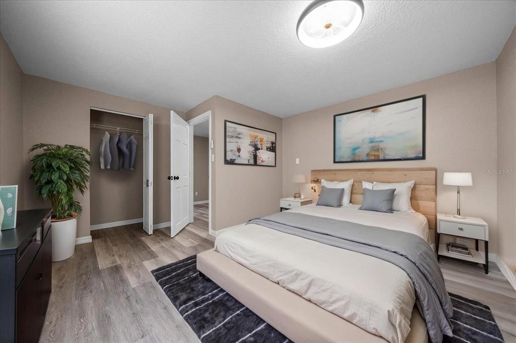 339 Southwest 83rd Street Ocala, FL 34476 - Photo 23 of 34 a bedroom with a large bed and a potted plant