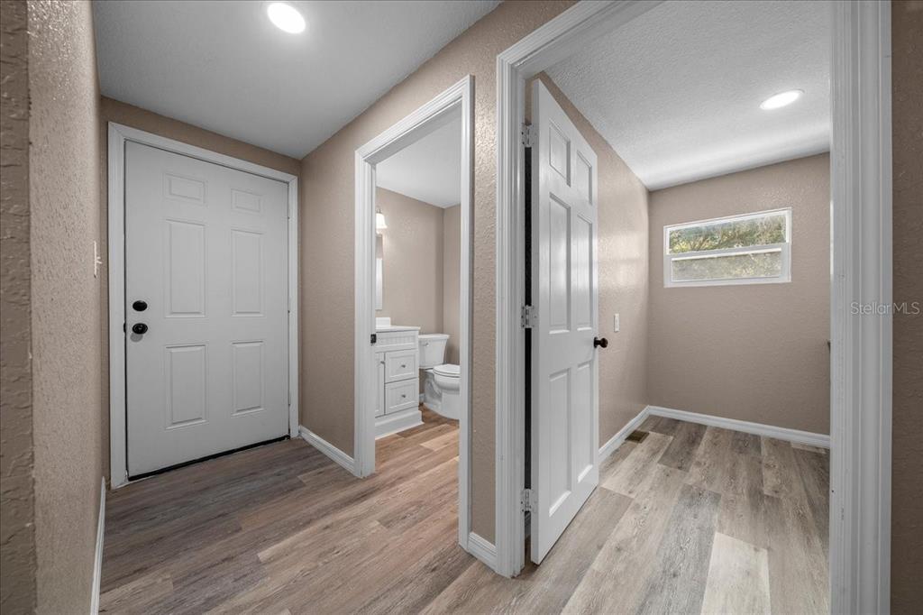 339 Southwest 83rd Street Ocala, FL 34476 - Photo 25 of 34 a view of a hallway with wooden floor and a bathroom